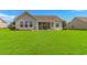 Lush green backyard with a view of the house at 5 Coffee Mill Creek Ln., Carolina Shores, NC 28467