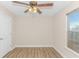 Bedroom featuring vinyl floors, a ceiling fan, and a window allowing natural light at 5 Coffee Mill Creek Ln., Carolina Shores, NC 28467