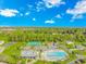 Aerial view showcases community pool, clubhouse, tennis courts, and scenic landscaping for active living at 5 Coffee Mill Creek Ln., Carolina Shores, NC 28467