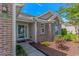 Inviting front entrance with brick accents, blue shutters, and a well-maintained landscape at 5 Coffee Mill Creek Ln., Carolina Shores, NC 28467