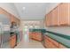 Open concept kitchen with stainless steel appliances, breakfast bar, and views into the adjacent dining area at 5 Coffee Mill Creek Ln., Carolina Shores, NC 28467