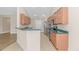 Functional kitchen layout with stainless steel appliances and a breakfast bar open to the living area at 5 Coffee Mill Creek Ln., Carolina Shores, NC 28467