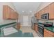 Well-lit kitchen with stainless steel appliances, wood cabinets, and green countertops at 5 Coffee Mill Creek Ln., Carolina Shores, NC 28467