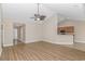 Bright living room showcasing hardwood floors, vaulted ceilings, and an open layout to the kitchen at 5 Coffee Mill Creek Ln., Carolina Shores, NC 28467