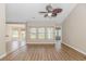 Spacious living room featuring hardwood floors, large windows, and an open floor plan at 5 Coffee Mill Creek Ln., Carolina Shores, NC 28467