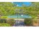 Well-maintained community tennis court surrounded by lush greenery for recreational enjoyment at 5 Coffee Mill Creek Ln., Carolina Shores, NC 28467