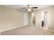 A carpeted bedroom with a view into the walk-in closet and en-suite bathroom at 500 Myrtle Greens Dr. # D, Conway, SC 29526