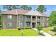 Attractive condo building with balconies, green lawn and mature trees at 500 Myrtle Greens Dr. # D, Conway, SC 29526