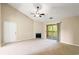 Bright living room with carpet, a fireplace, and sliding door access to a balcony at 500 Myrtle Greens Dr. # D, Conway, SC 29526
