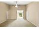 Open living room with carpeted floors, neutral paint, and a sliding door leading to a balcony at 500 Myrtle Greens Dr. # D, Conway, SC 29526