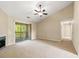 Spacious living room featuring a fireplace, carpeted floors, and sliding door to the balcony at 500 Myrtle Greens Dr. # D, Conway, SC 29526