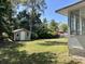 Spacious backyard with outbuilding and partial view of home and patio at 505 1St Ave. S, North Myrtle Beach, SC 29582