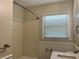 Bathroom with shower, toilet, sink, and window with blinds at 505 1St Ave. S, North Myrtle Beach, SC 29582