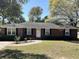 Charming red brick home with a well-maintained lawn and classic black shutters at 505 1St Ave. S, North Myrtle Beach, SC 29582