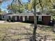 Red brick home showcasing a well-manicured lawn and mature shade trees in the front yard at 505 1St Ave. S, North Myrtle Beach, SC 29582
