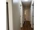 Hallway with fresh paint, wood floors, white trim, and multiple doors at 505 1St Ave. S, North Myrtle Beach, SC 29582