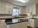 Updated kitchen with white cabinets, an island with a dark countertop, and stainless-steel appliances at 505 1St Ave. S, North Myrtle Beach, SC 29582