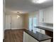 Bright eat-in kitchen with white cabinets, modern lighting, and hardwood floors at 505 1St Ave. S, North Myrtle Beach, SC 29582