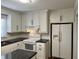 Bright kitchen featuring white cabinets, stainless steel appliances, and modern fixtures at 505 1St Ave. S, North Myrtle Beach, SC 29582