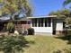 Brick home features light-filled sun room with large windows overlooking backyard at 505 1St Ave. S, North Myrtle Beach, SC 29582