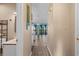Hallway leading to a brightly lit living area with sliding doors and modern flooring at 510 Fairwood Lakes Dr. # 19-Q, Myrtle Beach, SC 29588