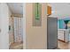 A hallway presents a bathroom featuring a shower curtain, and glimpses of a kitchen with updated appliances at 510 Fairwood Lakes Dr. # 19-Q, Myrtle Beach, SC 29588