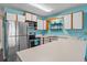 Updated kitchen with stainless steel appliances, white countertops and cabinets, and a stainless steel sink at 510 Fairwood Lakes Dr. # 19-Q, Myrtle Beach, SC 29588