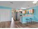 Updated kitchen features white cabinets, stainless appliances, breakfast bar, and modern fixtures at 510 Fairwood Lakes Dr. # 19-Q, Myrtle Beach, SC 29588