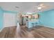 Open living room and kitchen with a breakfast bar, wood floors, stainless appliances, and a ceiling fan at 510 Fairwood Lakes Dr. # 19-Q, Myrtle Beach, SC 29588