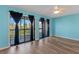 Spacious living room with modern floors, ceiling fan, and access to an outdoor balcony at 510 Fairwood Lakes Dr. # 19-Q, Myrtle Beach, SC 29588