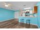 Open-concept living and kitchen area featuring wood floors, breakfast bar, and stainless steel appliances at 510 Fairwood Lakes Dr. # 19-Q, Myrtle Beach, SC 29588