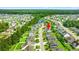 Aerial view of a neighborhood with lush trees, ponds, and houses, with an arrow pointing to a featured home at 5146 Fairmont Ln., Myrtle Beach, SC 29579