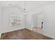The dining room features wood floors, wainscoting, a chandelier, and lots of light from a large window at 5146 Fairmont Ln., Myrtle Beach, SC 29579