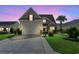 Charming home featuring a well-manicured lawn and a spacious driveway at twilight, creating a cozy ambiance at 5146 Fairmont Ln., Myrtle Beach, SC 29579