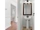 Elegant half bathroom with pedestal sink, decorative mirror and unique tiled floor at 5146 Fairmont Ln., Myrtle Beach, SC 29579