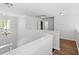 Bright hallway with hardwood floors, white railings and multiple entryways at 5146 Fairmont Ln., Myrtle Beach, SC 29579