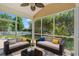 Inviting screened-in patio features comfortable seating and view of a lush backyard with a white picket fence at 5146 Fairmont Ln., Myrtle Beach, SC 29579