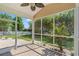 Covered and screened-in patio with ceiling fan, overlooking a well-maintained lawn and garden at 5146 Fairmont Ln., Myrtle Beach, SC 29579