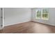 Bright and airy bedroom featuring hardwood floors and large windows at 5310 Knobcone Loop # B, Myrtle Beach, SC 29577