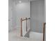 Hallway with wooden banister, offering a clear path between the upper and lower levels of the home at 5310 Knobcone Loop # B, Myrtle Beach, SC 29577