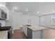Kitchen island with granite countertops, sink, and seating area at 5310 Knobcone Loop # B, Myrtle Beach, SC 29577