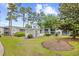 Serene backyard featuring lush greenery, garden, and additional storage at 5406 Sweetwater Blvd. # 5406, Murrells Inlet, SC 29576
