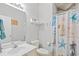 A well-lit bathroom featuring a vanity, toilet, and a shower with a decorative starfish curtain at 5406 Sweetwater Blvd. # 5406, Murrells Inlet, SC 29576