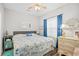 Bedroom featuring a king-sized bed with white and blue bedding and decoratively framed mirror and lamp at 5406 Sweetwater Blvd. # 5406, Murrells Inlet, SC 29576