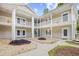 Attractive condo exterior with white pillars, balconies, manicured landscaping and inviting walkway at 5406 Sweetwater Blvd. # 5406, Murrells Inlet, SC 29576