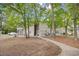 An exterior view of the property, showcasing the building's architecture and surrounding trees at 5406 Sweetwater Blvd. # 5406, Murrells Inlet, SC 29576