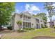Charming condo exterior with private screened porch, beautiful landscaping, and well-kept lawn at 5406 Sweetwater Blvd. # 5406, Murrells Inlet, SC 29576