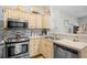 Well-lit kitchen featuring stainless steel appliances, light wood cabinets, and decorative backsplash at 5406 Sweetwater Blvd. # 5406, Murrells Inlet, SC 29576