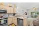 Bright kitchen featuring stainless steel appliances and light wood cabinets, opening to living area at 5406 Sweetwater Blvd. # 5406, Murrells Inlet, SC 29576