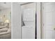 A stacked washer and dryer in an enclosed closet space, with the door ajar at 5406 Sweetwater Blvd. # 5406, Murrells Inlet, SC 29576